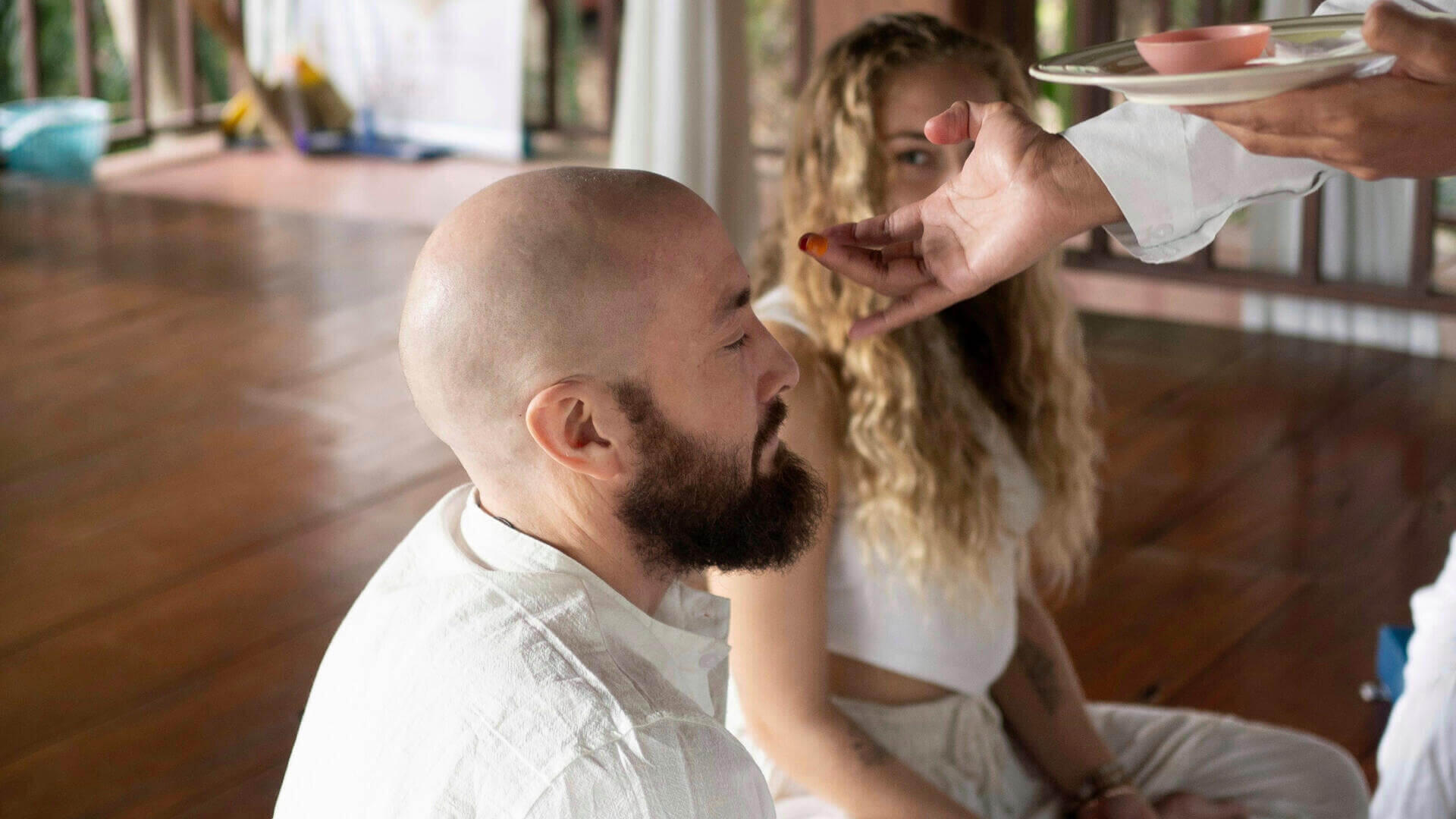 A yoga teacher during a ceremony at Yoga Vidya Mandiram teacher training